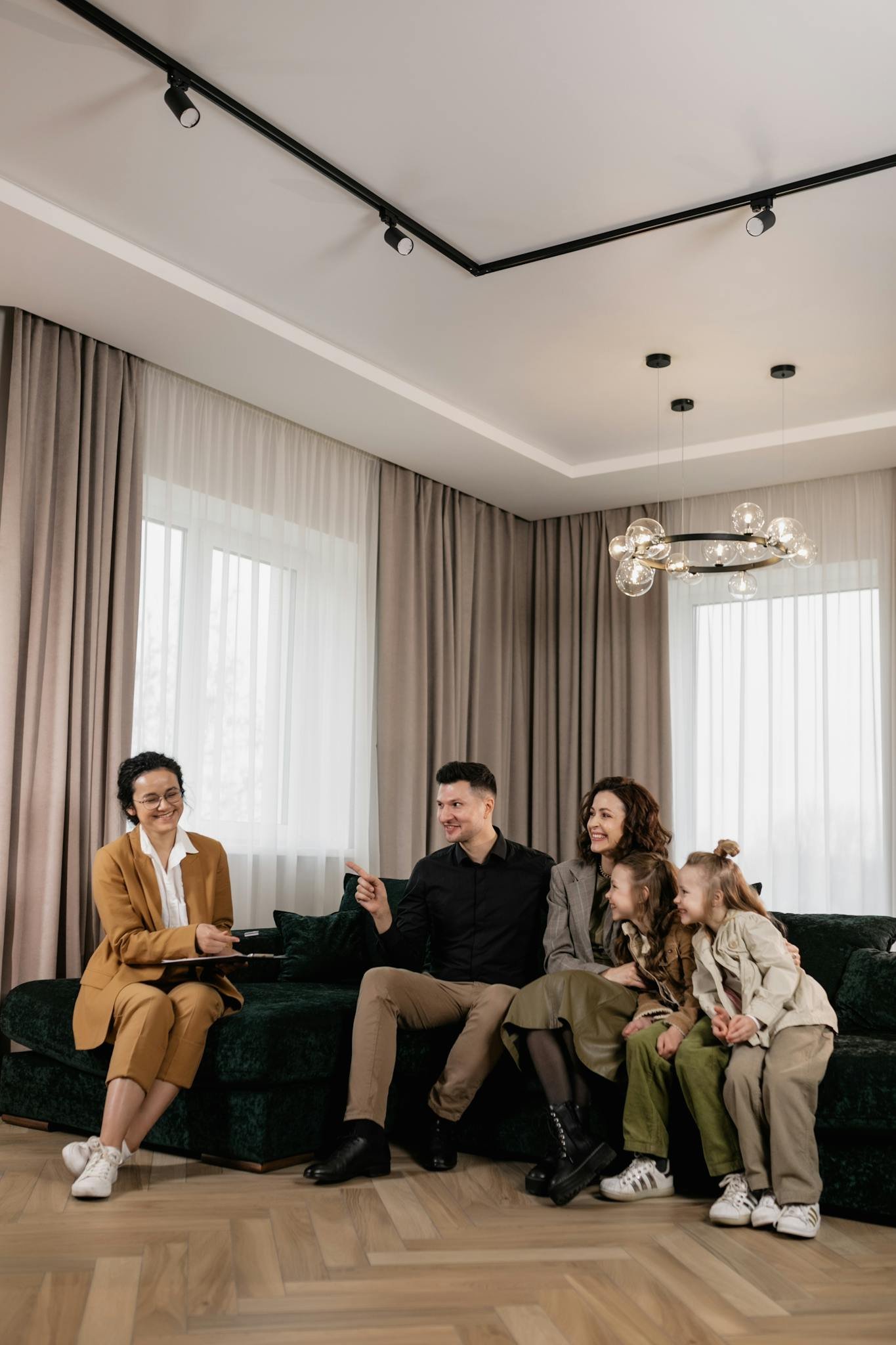 Family discusses new home purchase with real estate agent in a cozy living room setting.